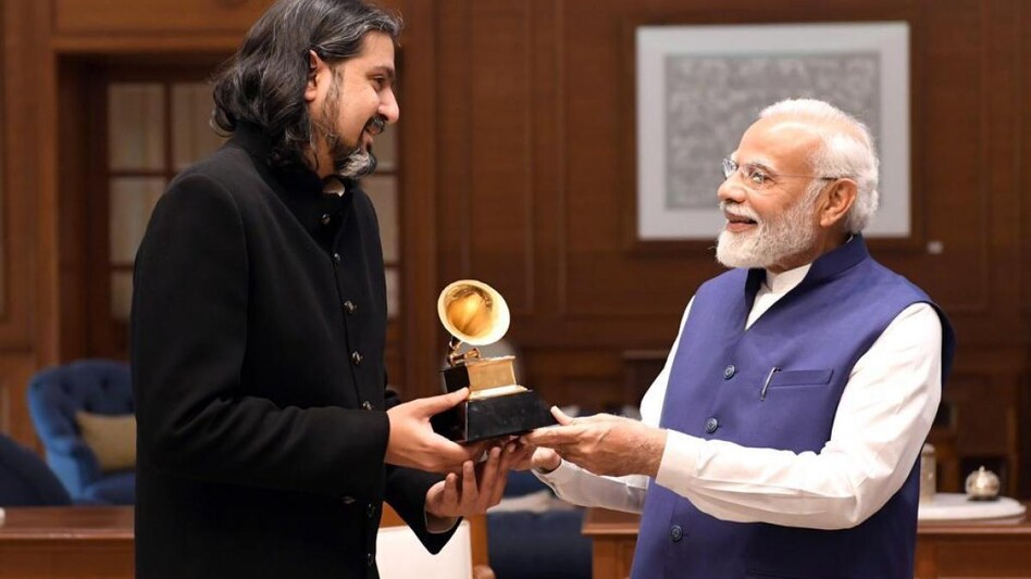 In one of the two photos shared by the Prime Minister, Kej is showing his Grammy Award to PM Modi. In one of the two photos shared by the Prime Minister, Kej is showing his Grammy Award to PM Modi.