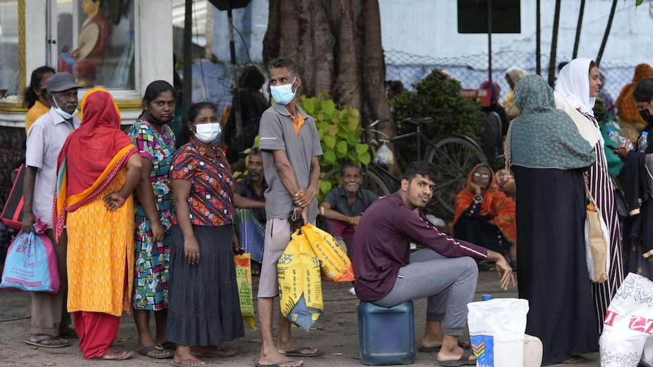 People wait in a fuel station to buy kerosene oil for cooking in Colombo, Sri Lanka. People wait in a fuel station to buy kerosene oil for cooking in Colombo, Sri Lanka.
