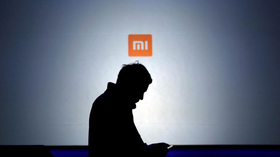 A man uses his mobile phone in front of a screen showing a logo of Xiaomi at the launch ceremony of the Mi Note in Beijing, Picture taken on January 15, 2015.(Photo: Reuters) A man uses his mobile phone in front of a screen showing a logo of Xiaomi at the launch ceremony of the Mi Note in Beijing, Picture taken on January 15, 2015.(Photo: Reuters)