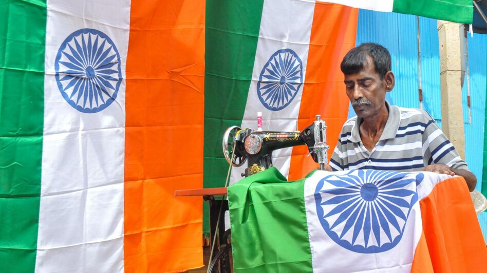 A worker stitches national flag ahead of Independence Day. (Photo: PTI) A worker stitches national flag ahead of Independence Day. (Photo: PTI)