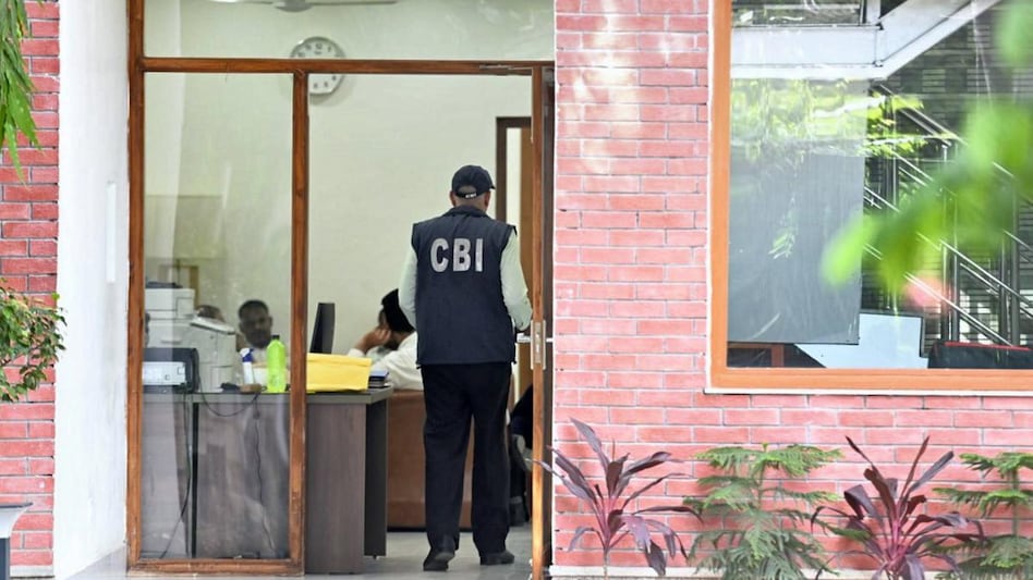 A CBI official during a raid at the residence of Delhi Deputy Chief Minister Manish Sisodia in connection with alleged irregularities in Delhi Excise Policy, in New Delhi A CBI official during a raid at the residence of Delhi Deputy Chief Minister Manish Sisodia in connection with alleged irregularities in Delhi Excise Policy, in New Delhi