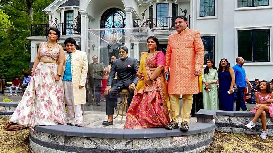 An Indian-American family poses for photos with a newly-installed life-size statue of Bollywood superstar Amitabh Bachchan at their residence during an unveiling ceremony, at Edison City in New Jersey. An Indian-American family poses for photos with a newly-installed life-size statue of Bollywood superstar Amitabh Bachchan at their residence during an unveiling ceremony, at Edison City in New Jersey.