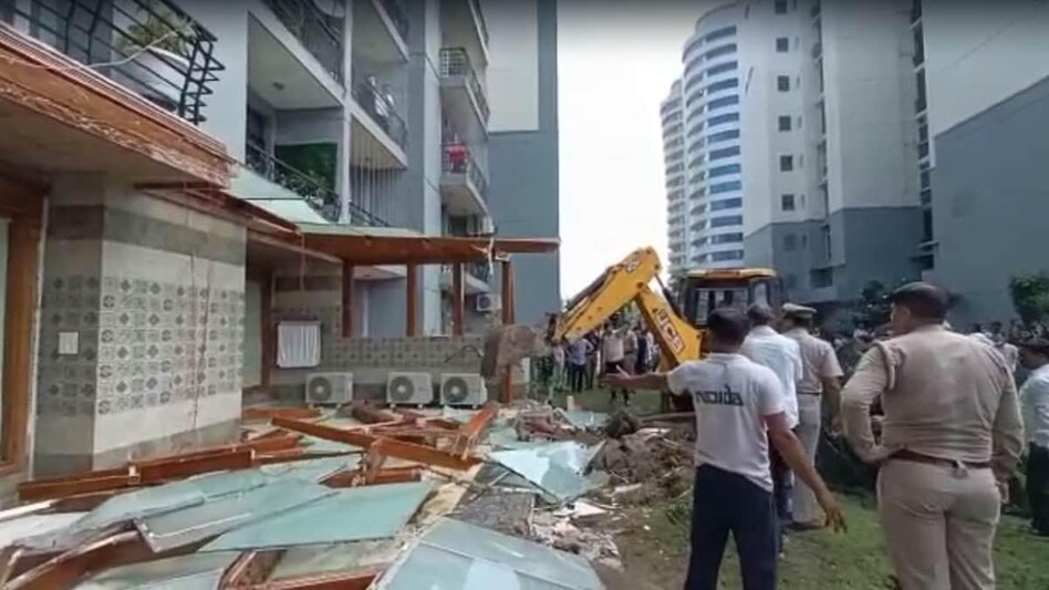Bulldozer removes illegal structures outside politician Shrikant Tyagi's Noida flat Bulldozer removes illegal structures outside politician Shrikant Tyagi's Noida flat