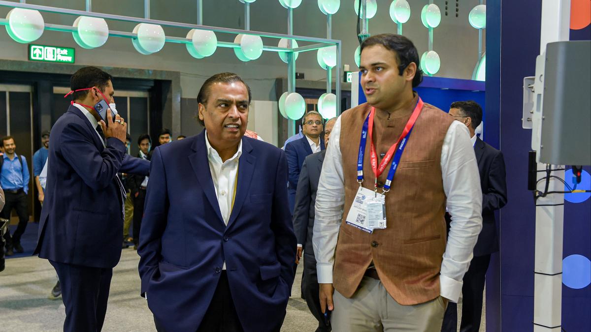 Reliance Industries Ltd Chairman Mukesh Ambani with Reliance Jio Senior Vice President Aayush Bhatnagar at Reliance Jio's stall during the 6th India Mobile Congress Reliance Industries Ltd Chairman Mukesh Ambani with Reliance Jio Senior Vice President Aayush Bhatnagar at Reliance Jio's stall during the 6th India Mobile Congress