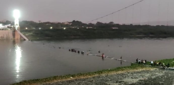 Rescue operation underway after an old suspension bridge over the Machchhu river collapsed, in Morbi district Rescue operation underway after an old suspension bridge over the Machchhu river collapsed, in Morbi district