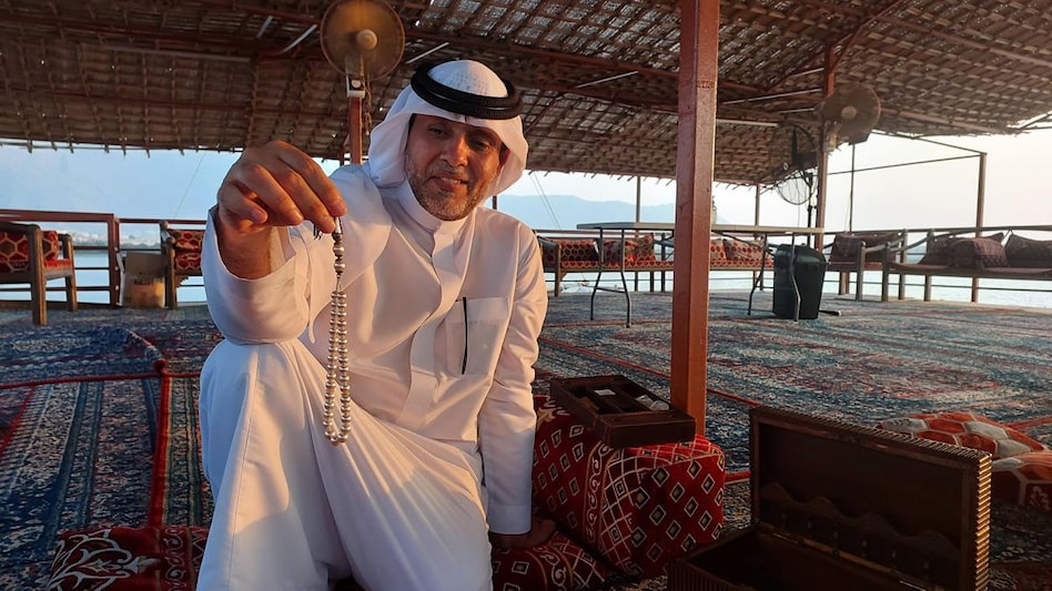 Abdulla Rashed Al-Suwaidi with a replica of prayer beads using Arabian pearls that he was specially commissioned to make for the Sultan of Oman Abdulla Rashed Al-Suwaidi with a replica of prayer beads using Arabian pearls that he was specially commissioned to make for the Sultan of Oman