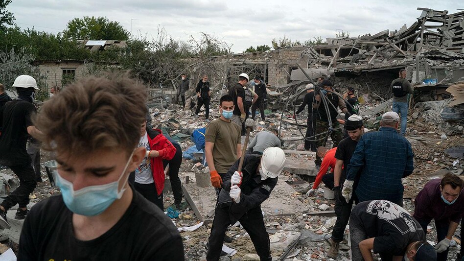 Volunteers work to clean the debris on a site where several houses were destroyed after a Russian attack Volunteers work to clean the debris on a site where several houses were destroyed after a Russian attack