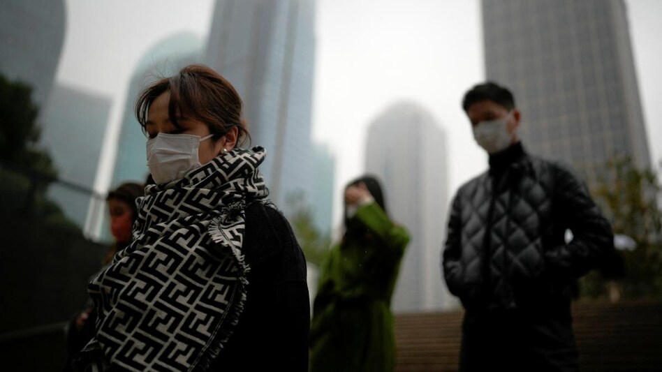 People wearing masks walk as coronavirus disease outbreaks continue in Shanghai People wearing masks walk as coronavirus disease outbreaks continue in Shanghai