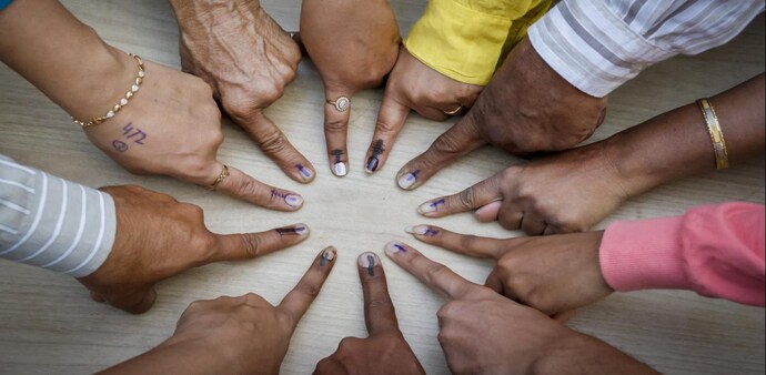 Voters pose for a photo showing their fingers marked with indelible ink after casting their votes Voters pose for a photo showing their fingers marked with indelible ink after casting their votes
