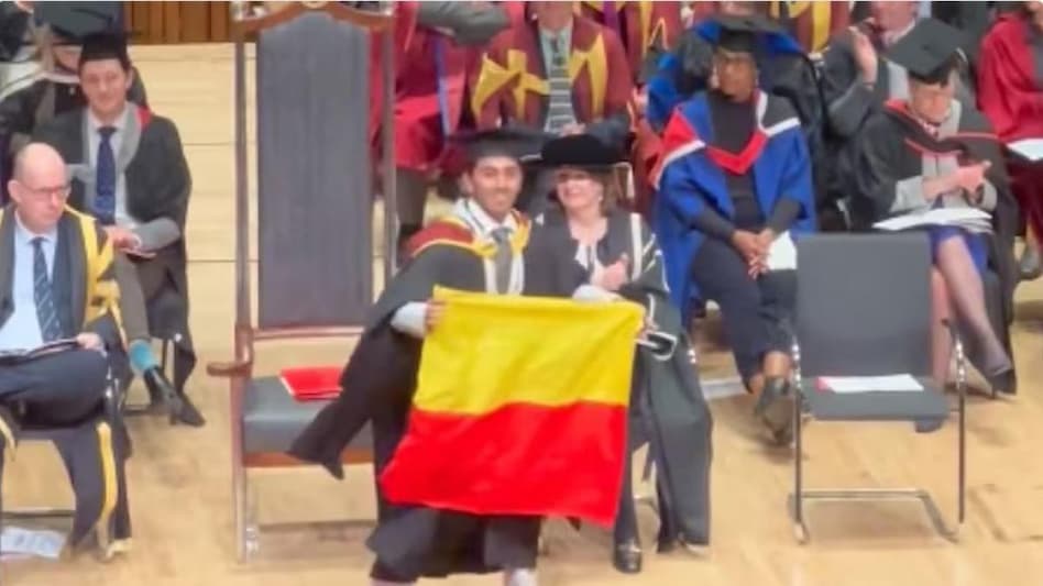 The debate began after Adhish R Wali, student union leader, shared the video in which he is seen unfurling the flag moments before collecting his degree. The debate began after Adhish R Wali, student union leader, shared the video in which he is seen unfurling the flag moments before collecting his degree.