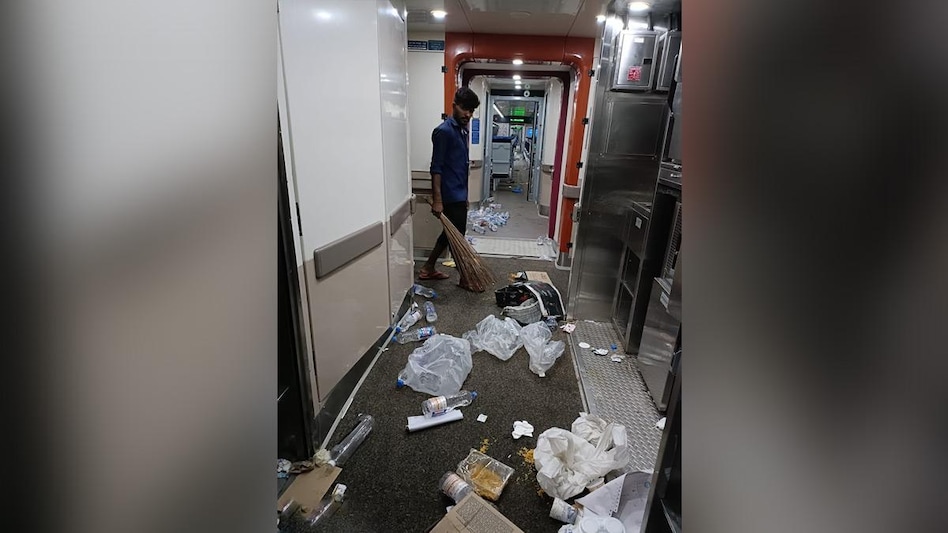 In the picture, empty bottles, plastic bags and used food containers can be seen thrown on the floor inside the train and a worker cleaning the mess with a broom. “We the people,” Awanish Sharan’s caption reads (Pic- Twitter) In the picture, empty bottles, plastic bags and used food containers can be seen thrown on the floor inside the train and a worker cleaning the mess with a broom. “We the people,” Awanish Sharan’s caption reads (Pic- Twitter)
