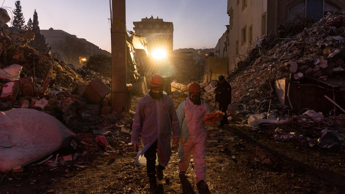 Rescue workers pass by in the aftermath of a deadly earthquake in Turkey