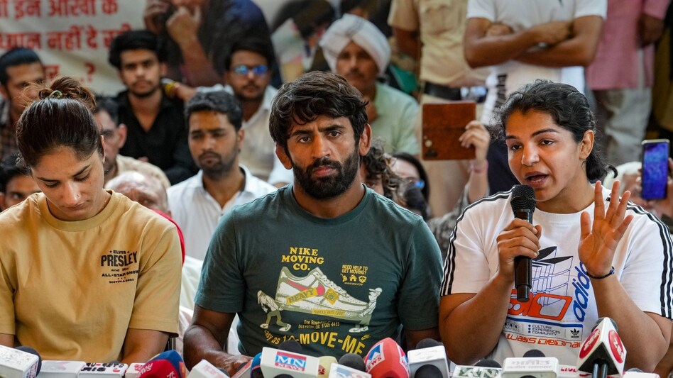 Wrestlers Bajrang Punia, Vinesh Phogat and Sakshi Malik address the media during their protest against Wrestling Federation of India (WFI) chief Brij Bhushan Sharan Singh, at Jantar Mantar in New Delhi Wrestlers Bajrang Punia, Vinesh Phogat and Sakshi Malik address the media during their protest against Wrestling Federation of India (WFI) chief Brij Bhushan Sharan Singh, at Jantar Mantar in New Delhi