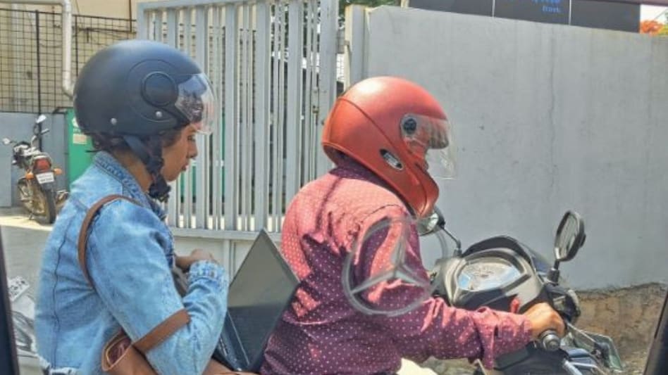 Peak Bengaluru moment! Viral picture shows woman working on her laptop while being stuck in traffic Peak Bengaluru moment! Viral picture shows woman working on her laptop while being stuck in traffic