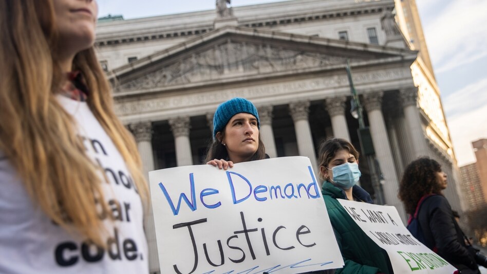 Protesters hold placards during a rally for survivors of Jeffrey Epstein in New York City Protesters hold placards during a rally for survivors of Jeffrey Epstein in New York City