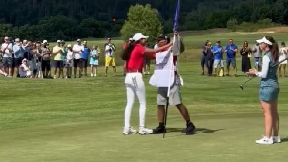 Twitter grab of Diksha Dagar being congratulated by her father and caddie Narinder following her winning putt at Royal Beroun Golf Club on Sunday. Twitter grab of Diksha Dagar being congratulated by her father and caddie Narinder following her winning putt at Royal Beroun Golf Club on Sunday.