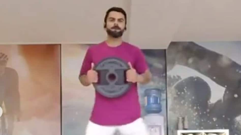 In the captivating footage, Kohli is seen engaged in an intense weight training session at his gym. In the captivating footage, Kohli is seen engaged in an intense weight training session at his gym.
