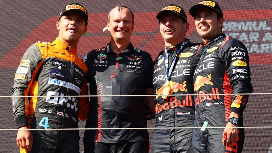 Formula One F1 - Hungarian Grand Prix - Red Bull's Max Verstappen celebrates on the podium after winning the Hungarian Grand Prix alongside second place McLaren's Lando Norris and third place Sergio Perez Formula One F1 - Hungarian Grand Prix - Red Bull's Max Verstappen celebrates on the podium after winning the Hungarian Grand Prix alongside second place McLaren's Lando Norris and third place Sergio Perez