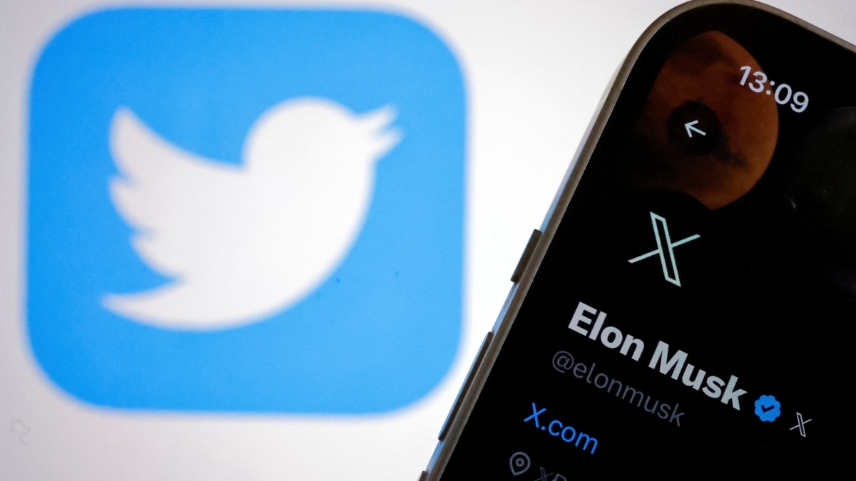 The new logo of Twitter is seen on Elon Musk’s Twitter account on an iPhone as the old Twitter logo is displayed on a MacBook screen The new logo of Twitter is seen on Elon Musk’s Twitter account on an iPhone as the old Twitter logo is displayed on a MacBook screen