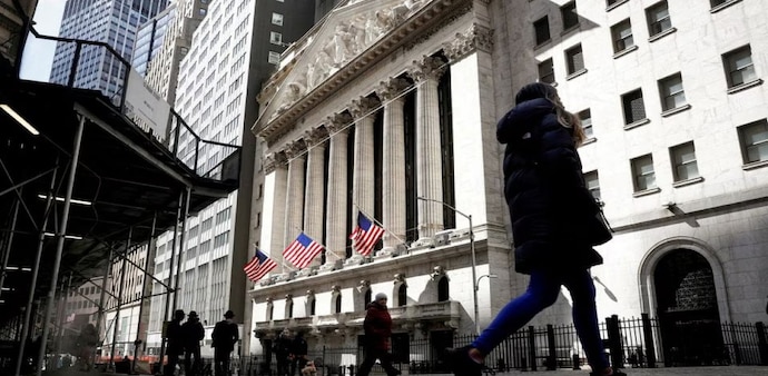 People are seen on Wall Street outside the New York Stock Exchange (NYSE) in New York City, U.S. People are seen on Wall Street outside the New York Stock Exchange (NYSE) in New York City, U.S.