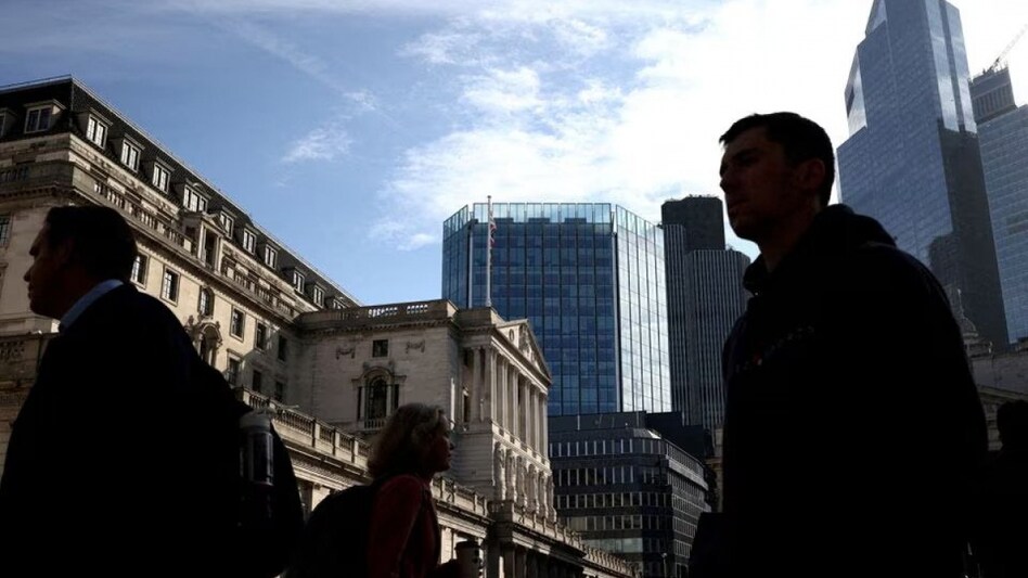 People walk outside the Bank of England in the City of London financial district in London, Britain People walk outside the Bank of England in the City of London financial district in London, Britain