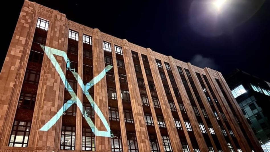 The new Twitter logo being projected on a building The new Twitter logo being projected on a building