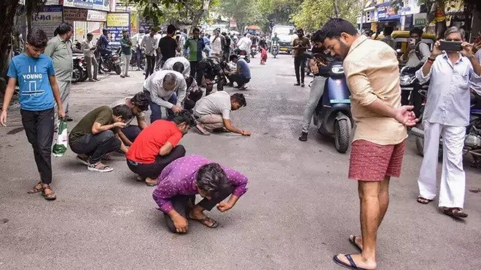 A video of locals searching for diamonds dropped on a road in Surat, has gone viral A video of locals searching for diamonds dropped on a road in Surat, has gone viral