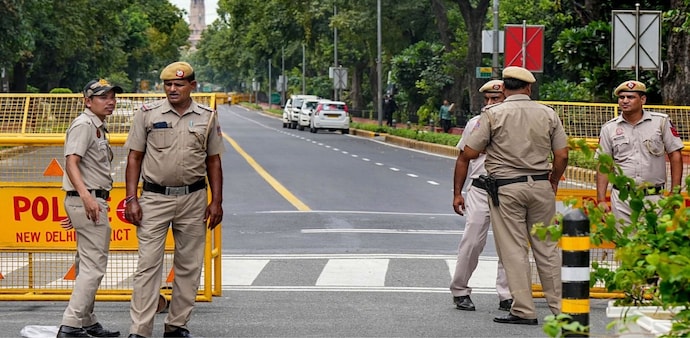 Police personnel stand guard at a barricaded road near Raisina Road ahead of the upcoming G20 Summit, in New Delhi (PTI Photo/Shahbaz Khan) Police personnel stand guard at a barricaded road near Raisina Road ahead of the upcoming G20 Summit, in New Delhi (PTI Photo/Shahbaz Khan)