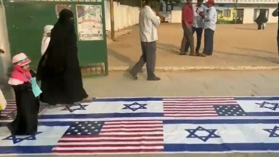 The flags of US and Israel were kept on the ground at the entrance of the dargah in the Saidabad area. The flags of US and Israel were kept on the ground at the entrance of the dargah in the Saidabad area.
