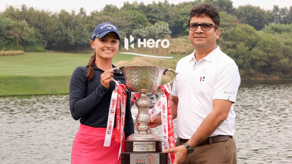 Hero Women’s Indian Open 2023 champion Aline Krauter of Germany with Hero MotoCorp CEO Niranjan Gupta and her trophy in Gurgaon on Sunday. Image courtesy Ladies European Tour Hero Women’s Indian Open 2023 champion Aline Krauter of Germany with Hero MotoCorp CEO Niranjan Gupta and her trophy in Gurgaon on Sunday. Image courtesy Ladies European Tour