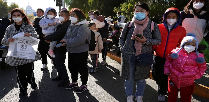 People wait outside a hospital in China due to the 'mysterious pneumonia' outbreak People wait outside a hospital in China due to the 'mysterious pneumonia' outbreak