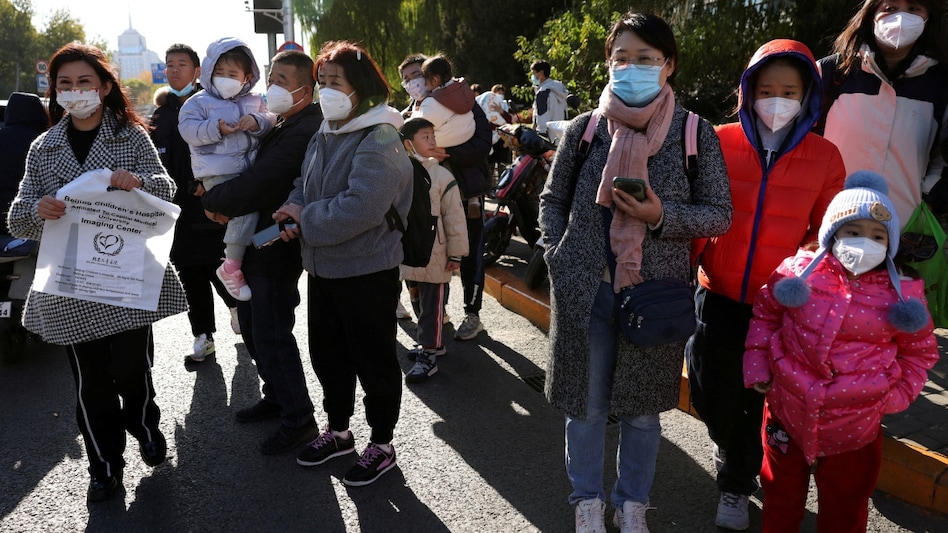 People wait outside a hospital in China due to the 'mysterious pneumonia' outbreak People wait outside a hospital in China due to the 'mysterious pneumonia' outbreak