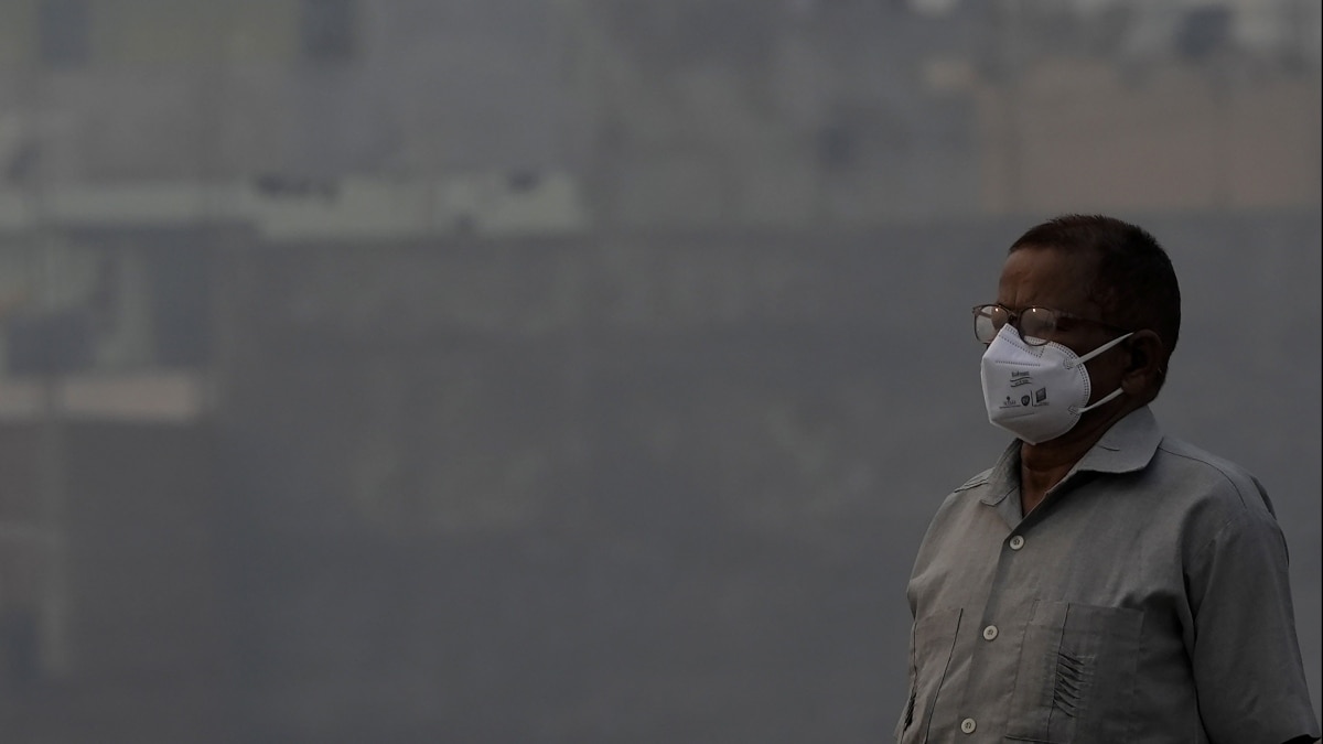 A man wears anti-pollution mask to protect himself from growing level of air pollution, in New Delhi (PTI Photo/Atul Yadav)