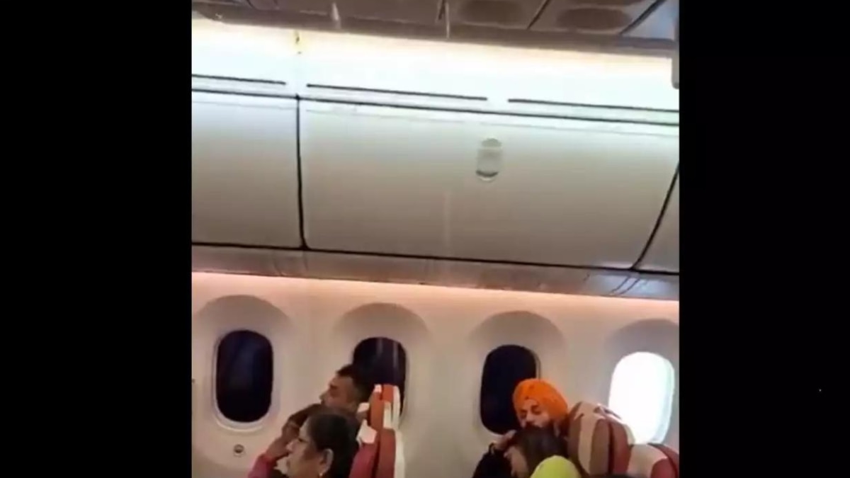 The video reveals a continuous flow of water from the overhead bin within the Air India flight The video reveals a continuous flow of water from the overhead bin within the Air India flight