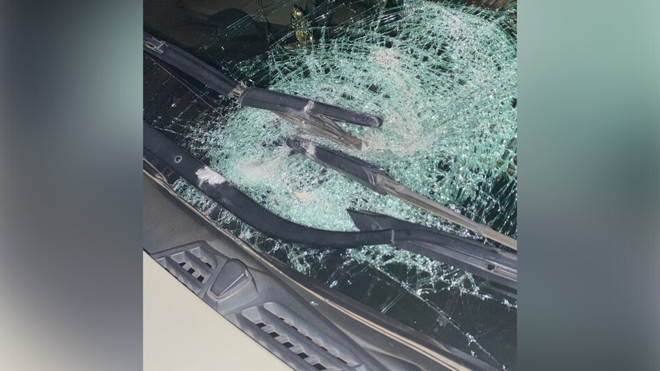 The cement block hit the windshield of his car, causing it to shatter. The cement block hit the windshield of his car, causing it to shatter.