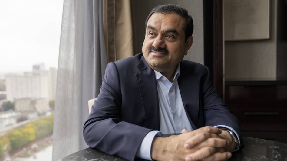 Jim Walton at $70.5 billion stands just above Adani at 15th spot. Adani's wealth likely swelled on Tuesday morning, as group shares added about Rs 90,000 crore in market capitalisation (m-cap) intraday. Jim Walton at $70.5 billion stands just above Adani at 15th spot. Adani's wealth likely swelled on Tuesday morning, as group shares added about Rs 90,000 crore in market capitalisation (m-cap) intraday.