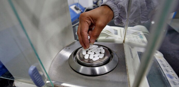 A pharmacist checks weight of medicine A pharmacist checks weight of medicine