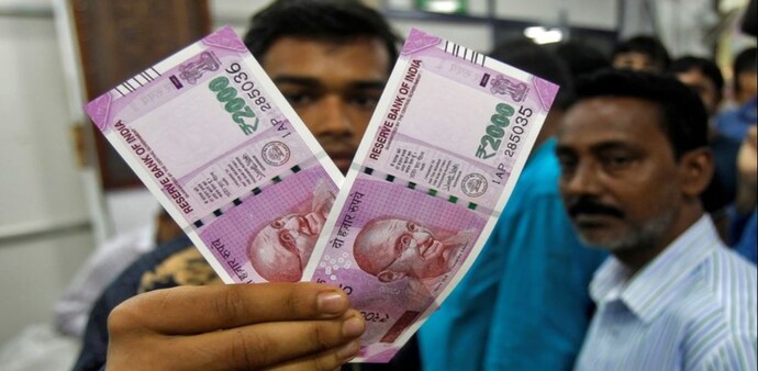 Man holding Rs 2,000 notes Man holding Rs 2,000 notes