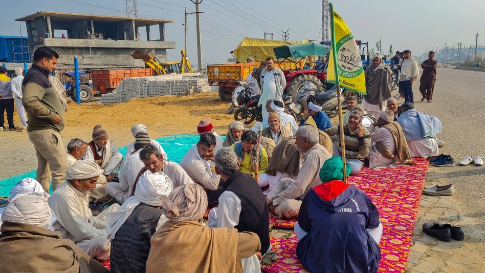 Farmers gather near the Titoli village on Rohtak-Jind Road for their 'Delhi Chalo' march (PTI) Farmers gather near the Titoli village on Rohtak-Jind Road for their 'Delhi Chalo' march (PTI)