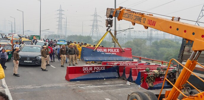 Barricades put up in view of farmers' protest march being removed to open the road for traffic, at Ghazipur border, in New Delhi Barricades put up in view of farmers' protest march being removed to open the road for traffic, at Ghazipur border, in New Delhi