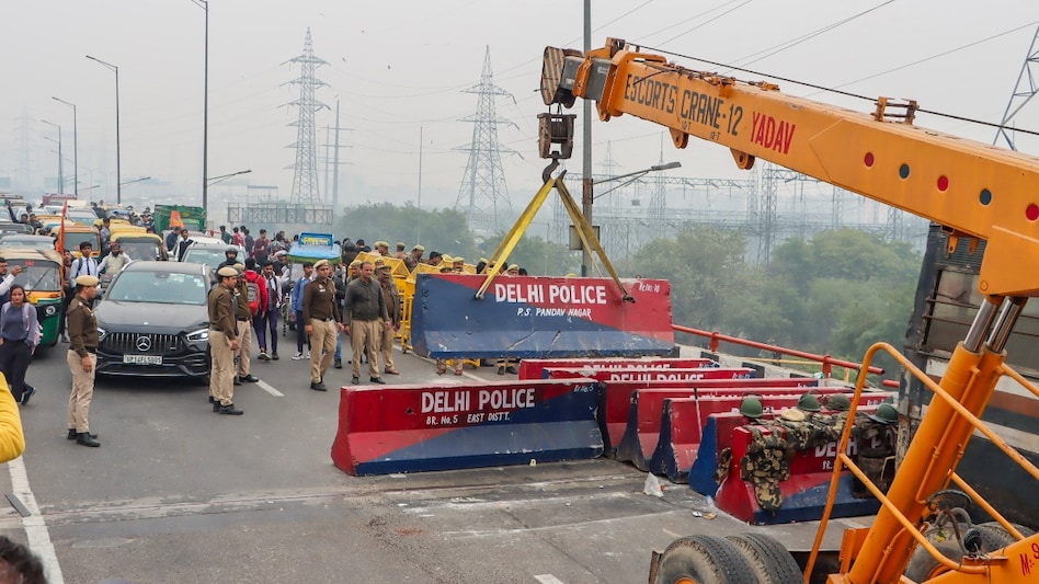 Barricades put up in view of farmers' protest march being removed to open the road for traffic, at Ghazipur border, in New Delhi Barricades put up in view of farmers' protest march being removed to open the road for traffic, at Ghazipur border, in New Delhi