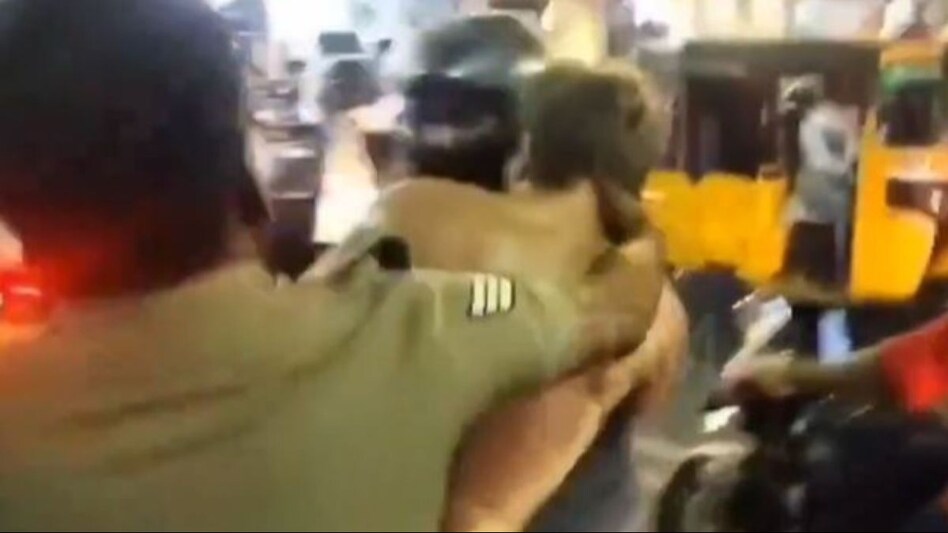 As the chaos unfolded, a crowd gathered around the scene, watching as the perpetrator was subdued against an iron railing by police. As the chaos unfolded, a crowd gathered around the scene, watching as the perpetrator was subdued against an iron railing by police.