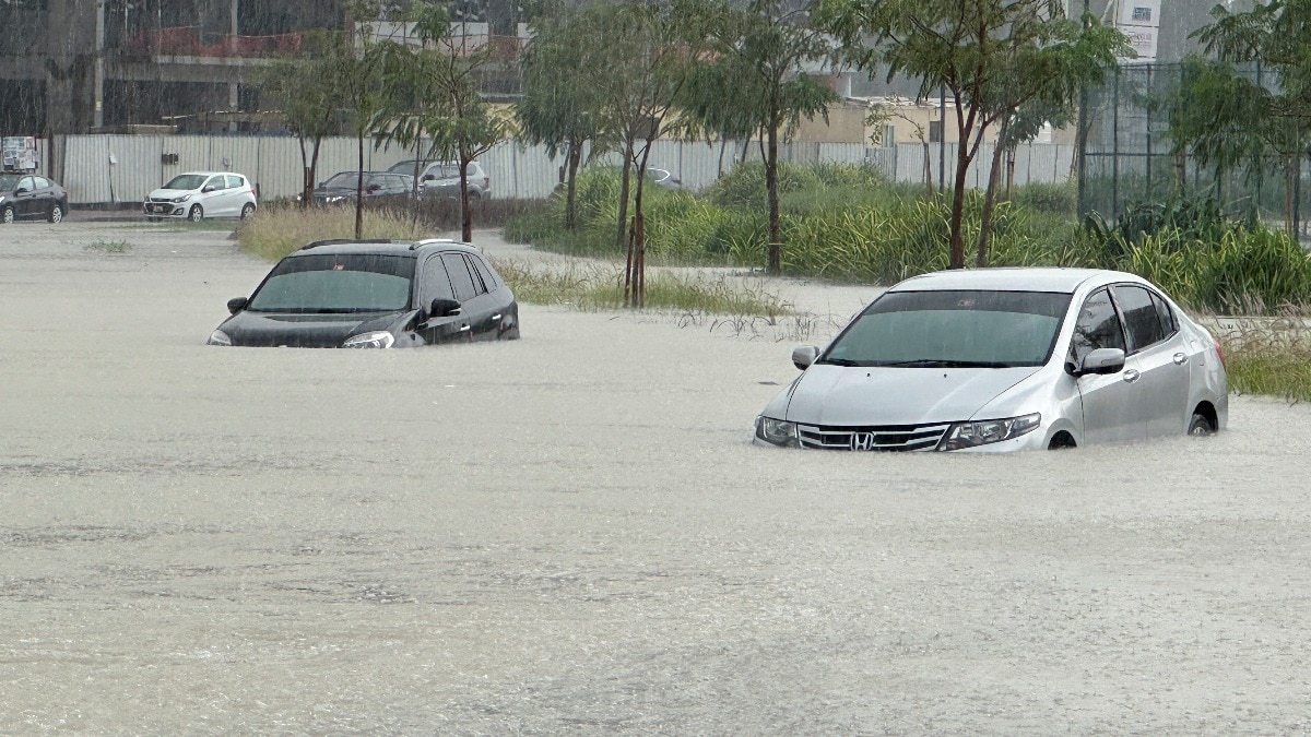 Cars drive through a flooded street during a rain storm in Dubai. (Image: Reuters) Cars drive through a flooded street during a rain storm in Dubai. (Image: Reuters)