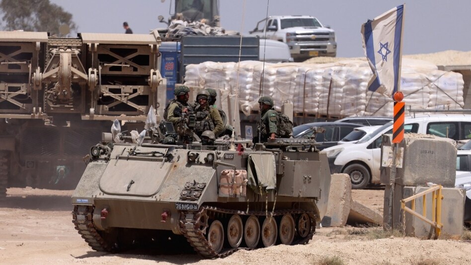 This picture taken from Israel's southern border with the Gaza Strip shows Israeli military vehicles along the border with the Palestinian territory. (AFP) This picture taken from Israel's southern border with the Gaza Strip shows Israeli military vehicles along the border with the Palestinian territory. (AFP)
