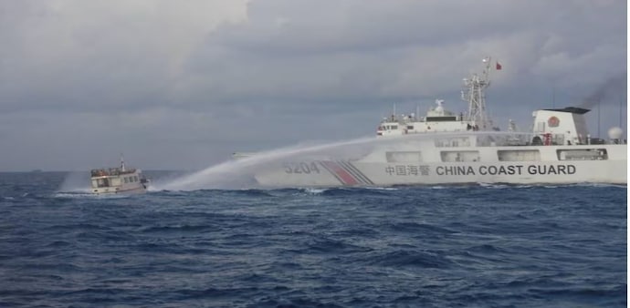 A Chinese Coast Guard ship uses a water cannon against a Filipino resupply vessel heading towards the disputed Second Thomas Shoal, in the South China Sea, December 10, 2023. (Reuters) A Chinese Coast Guard ship uses a water cannon against a Filipino resupply vessel heading towards the disputed Second Thomas Shoal, in the South China Sea, December 10, 2023. (Reuters)