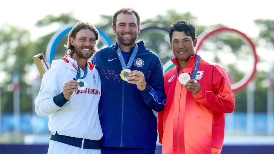 The three golf medallists on the Paris podium at Guyancourt on Sunday (from left) Tommy Fleetwood of England (silver), American Scottie Scheffler (gold) and Hideki Matsuyama of Japan (bronze). Image courtesy Olympic Golf. The three golf medallists on the Paris podium at Guyancourt on Sunday (from left) Tommy Fleetwood of England (silver), American Scottie Scheffler (gold) and Hideki Matsuyama of Japan (bronze). Image courtesy Olympic Golf.
