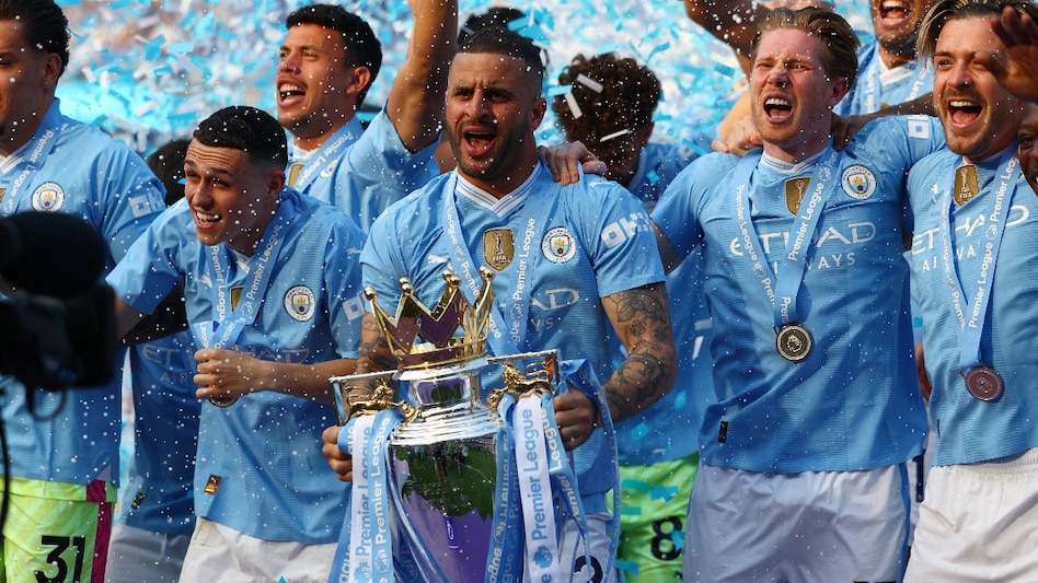 Manchester City's Kyle Walker and teammates celebrate with the trophy after winning the Premier League Manchester City's Kyle Walker and teammates celebrate with the trophy after winning the Premier League