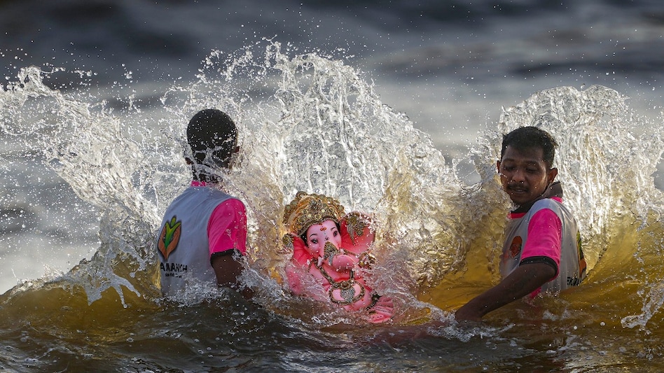 Devotees immerse an idol of Ganesha in the Arabian Sea during the ‘Ganesh Chaturthi’ festival in Mumbai on September 11. Devotees immerse an idol of Ganesha in the Arabian Sea during the ‘Ganesh Chaturthi’ festival in Mumbai on September 11.