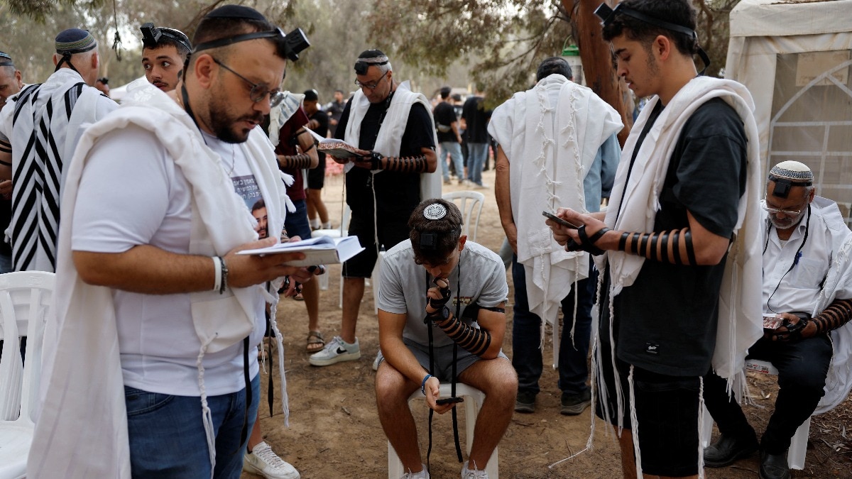People pray during a gathering to mark the anniversary since partygoers were killed and kidnapped during the deadly October 7 attack by Hamas, at the site of the Nova festival in Reim, southern Israel. People pray during a gathering to mark the anniversary since partygoers were killed and kidnapped during the deadly October 7 attack by Hamas, at the site of the Nova festival in Reim, southern Israel.