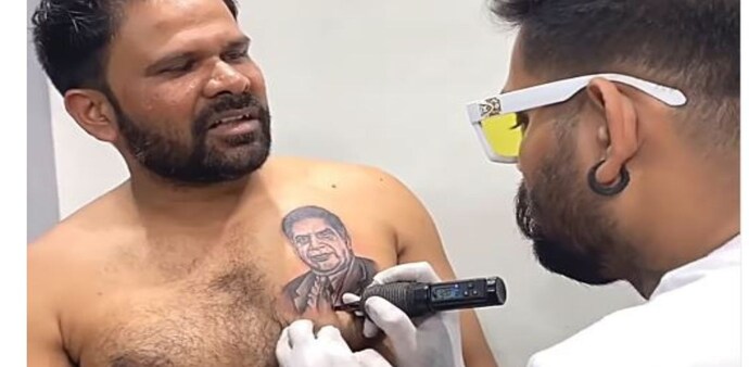 In the video, Chavan asks the man why he chose to honor Tata with a tattoo. In the video, Chavan asks the man why he chose to honor Tata with a tattoo.